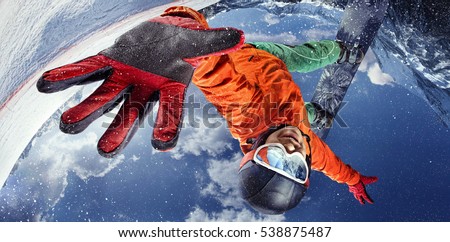 Sport background. Winter sport. Snowboarder jumping through air with deep blue sky in background. Royalty-Free Stock Photo #538875487