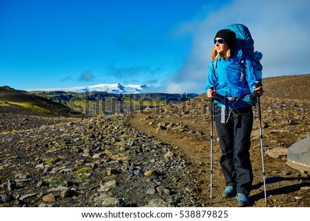 woman hiker on the trail in the Islandic mountains. woman standing and posing against the backdrop of a desert mountain landscape. Treking in National Park Landmannalaugar, Iceland. Travel photography Royalty-Free Stock Photo #538879825