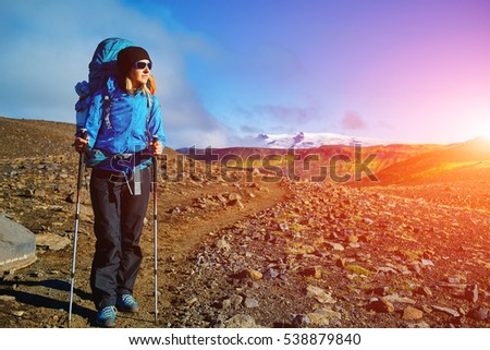 woman hiker on the trail in the Islandic mountains. woman standing and posing against the backdrop of a desert mountain landscape. Treking in National Park Landmannalaugar, Iceland. Travel photography Royalty-Free Stock Photo #538879840