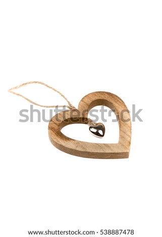Winter, Christmas, New Year wooden pine tree decoration - natural brown heart, prepared from solid wood. Isolated on white background. Wooden decor - heart. Side view. Closeup.