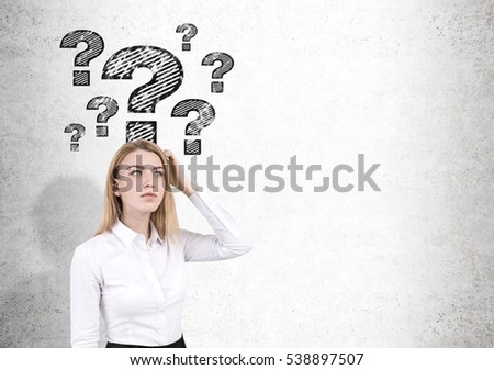 Blond woman in shirt is scratching her head while standing near a concrete wall with question marks. Mock up