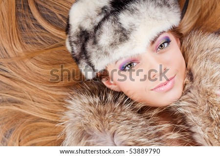 Young pretty girl in white fur hat