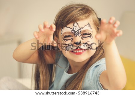 Portrait of funny girl with face painting on blurred background Royalty-Free Stock Photo #538916743