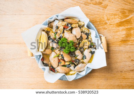 Fried clams with white wine in pan on wooden table - Processing Warm white balance