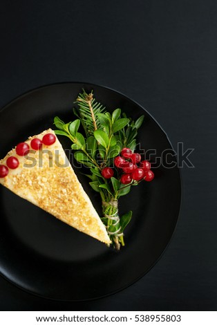 piece of delicious cake decorated Christmas tree and red berries