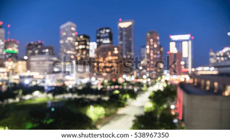 Blurred abstract with bokeh light downtown Houston illuminated at blue hour with green city park and modern skylines light. The most populous city in Texas and fourth-most in America. Panorama view.