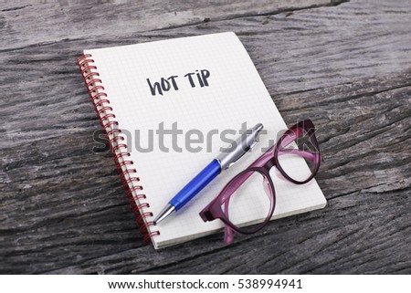 Note with hot tip on the wooden background