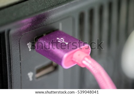Pink USB head connected with PC desktop