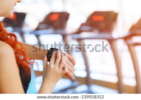 Burning calories. Cropped closeup of a fit woman looking at her smart watch counting burned calories during her workout at the gym. Woman using fitness bracelet copyspace Royalty-Free Stock Photo #539058352