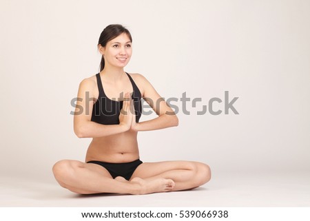 Yoga girl meditating indoor.