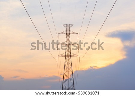 Silhouette of high voltage electricity poles at sunset background