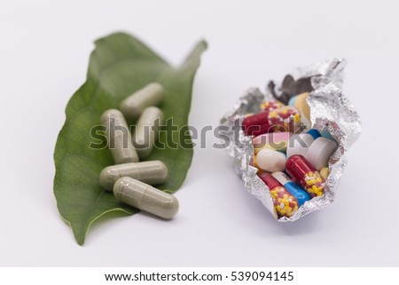 Comparing many pills of conventional or modern medicine versus one capsule of traditional,alternative, herbal elderberry medicine Royalty-Free Stock Photo #539094145