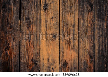 Old rural wooden wall in dark brown and orange colors, detailed plank photo texture. Natural wooden building structure background.