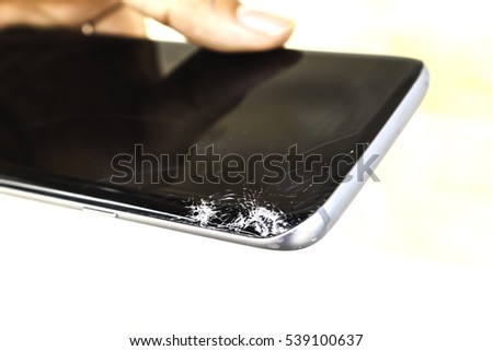 Hand hold the broken black mobile phone with isolated