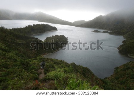 Lagoa do Fogo, a volcanic lake in Sao Miguel, Azores under the dramatic clouds and fog