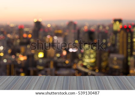 Opening wooden floor, blurred lights city business downtown background