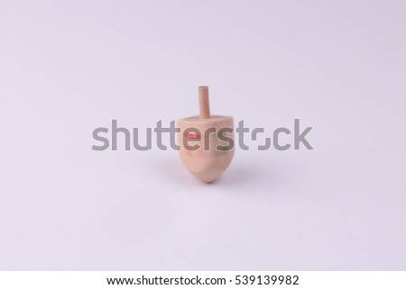 Image of jewish holiday Hanukkah with wooden dreidel (spinning top) fast 