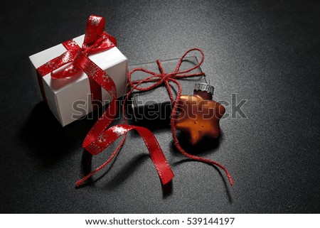christmas gifts with bauble on black background
