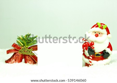 santa claus doll stand on snow with copy space
