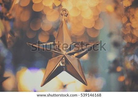 Winter holiday,Gold Star Christmas on vintage color bokeh background.picture do fade for text.
