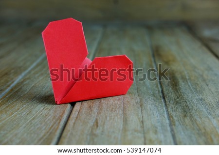 Close up of Red heart  paper on wooden background idea, selective focus, valentine day.