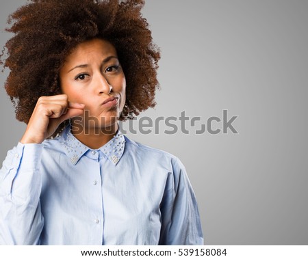 young black woman doing silence gesture