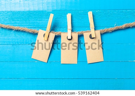 paper attach to rope with clothes pins on wooden background