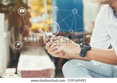 Internet of things concept.Business man hands holding touch screen smartphone outside in the park,color filter