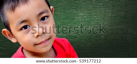 Closeup face 5 year old little boy Asia thinking about Something on background chalkboard copy Space For Graphic or description imagination designs Concept Education.