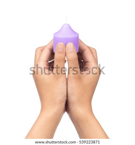hand holding purple candle isolated on white background