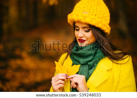 beautiful lady holding a maple leaf