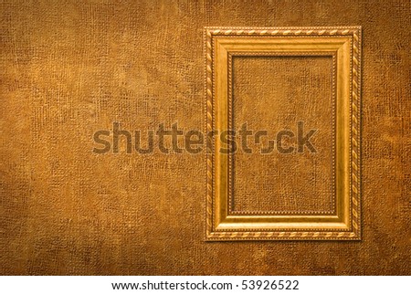 Gold frame on a yellow wall background