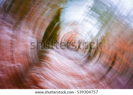 Abstract winter forest background. Blurry abstraction with motion effect.