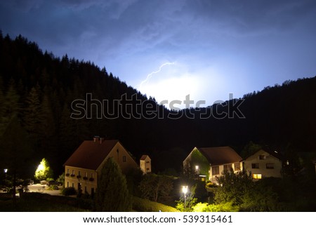 A heavy thunderstorm passes over the small Styrian mountain village Kleinfeistritz in Austria.