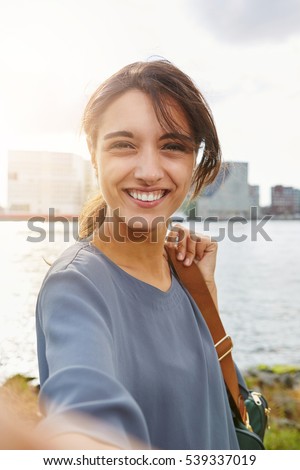 Close up portrait of attractive young woman talking selfie and smiling