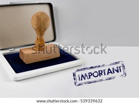 Wooden stamp on a desk IMPORTANT