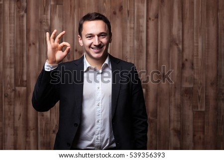 businessman looking through a frame on the wooden background