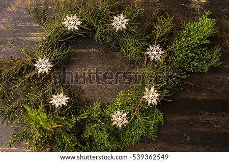 Border, frame from christmas tree branches on dark wooden background