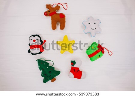 Christmas decorations felt  toys penguin deer sock star snowflake on  white wooden background