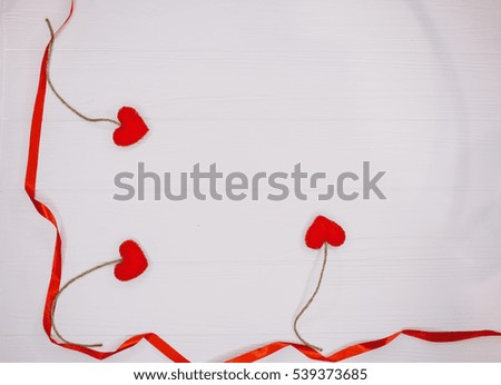 Christmas decorations red ribbon with felt handmade toys on  white wooden background