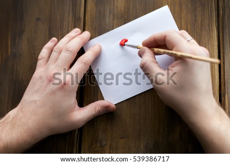 On a white sheet, vintage background, with red paint men's hand-written greetings with Valentine's day