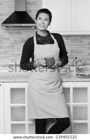 A beautiful woman in her kitchen during her breakfast