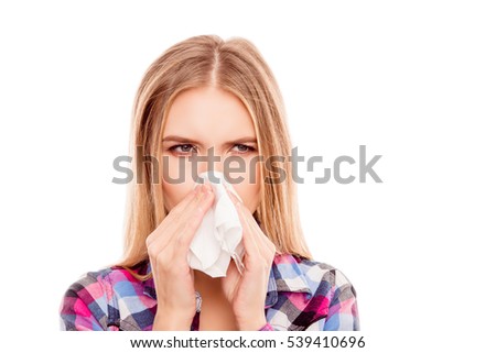 Young sick woman having allergy and sneezing in tissue Royalty-Free Stock Photo #539410696
