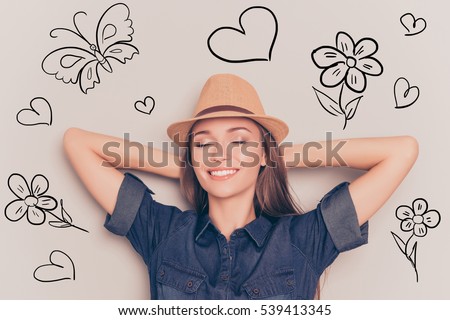 Young relaxed woman with closed eyes touching head and dreaming