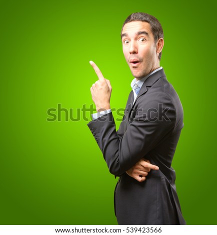 Funny businessman pointing up
