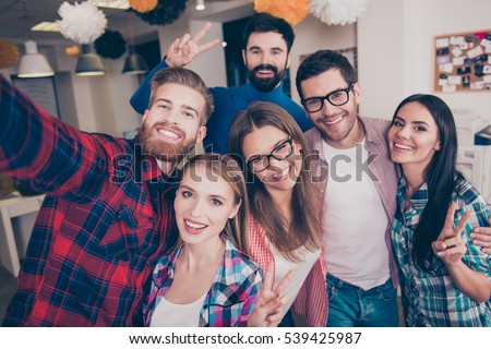 It's party time! six young carefree  attractive happy friends  gesturing v-sign while making selfie Royalty-Free Stock Photo #539425987