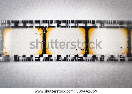 Macro closeup on blank filmstrip isolated on white with copy space