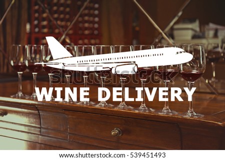 Glasses of red wine on table. Airplane and text WINE DELIVERY on background