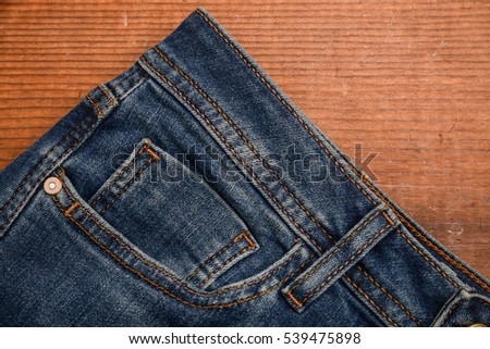 Details from blue jeans and board background