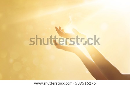 Woman hand praying for blessing from god on sunset background

